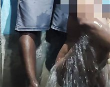 Husband helps his wife bathing